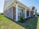 Charming front porch with classic columns, complemented by beautiful landscaping and lush green grass at 7209 Glen Park Ln, Indianapolis, IN 46259