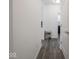 Hallway with grey vinyl floors provides a view of the shoe rack and a doorway to another room at 7209 Glen Park Ln, Indianapolis, IN 46259