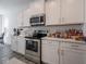 Modern kitchen features stainless steel appliances, white cabinets, and tile backsplash at 7209 Glen Park Ln, Indianapolis, IN 46259