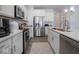 A contemporary kitchen featuring white cabinets, stainless steel appliances, and a tile backsplash at 7209 Glen Park Ln, Indianapolis, IN 46259