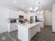 Bright kitchen with white cabinets, stainless steel appliances, and a quartz island at 7209 Glen Park Ln, Indianapolis, IN 46259