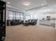 Open-concept living room with a gray sofa and view of the kitchen and dining area at 7209 Glen Park Ln, Indianapolis, IN 46259