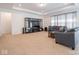 Bright and airy living room featuring recessed lights, a gray sofa, and media console at 7209 Glen Park Ln, Indianapolis, IN 46259