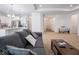 Open-concept living room featuring a gray sofa, recessed lights, and an open layout to the kitchen at 7209 Glen Park Ln, Indianapolis, IN 46259