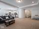 Open concept living room with access to kitchen and entryway, featuring neutral colored carpet at 7209 Glen Park Ln, Indianapolis, IN 46259