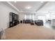 Spacious living room with neutral carpet, recessed lighting, and comfortable gray sofas at 7209 Glen Park Ln, Indianapolis, IN 46259
