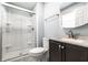 Well-lit bathroom featuring a glass shower, a white toilet, and a vanity with a sink at 7230 Carrie Dr, Indianapolis, IN 46237