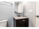 Bathroom vanity with a countertop sink, a faucet, a mirror, and a light switch at 7230 Carrie Dr, Indianapolis, IN 46237