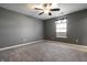 Cozy bedroom with a ceiling fan, a window, and neutral-colored walls at 7230 Carrie Dr, Indianapolis, IN 46237
