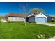 Attractive single Gathering home with green lawn, blue accents, and attached two car garage at 7230 Carrie Dr, Indianapolis, IN 46237