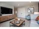 A modern living room features a large screen TV, a media cabinet and cozy decor at 7319 Deerberg Dr, Indianapolis, IN 46259
