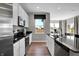 Well-lit kitchen featuring white cabinetry, stainless steel appliances, and an expansive view of the outside landscape at 7378 Standish Ln, Avon, IN 46123