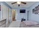 Cozy bedroom featuring a ceiling fan, mounted TV, and modern decor at 7441 Sugar Pine Ct, Avon, IN 46123