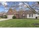 Side view of home showing brick and siding, well kept lawn, and mature tree providing shade at 7441 Sugar Pine Ct, Avon, IN 46123