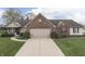 Charming single-story home featuring brick accents, a well-manicured lawn, and an attached two-car garage at 7441 Sugar Pine Ct, Avon, IN 46123
