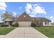 Inviting one-story residence with brick facade, neutral siding, lush lawn and driveway leading to an attached garage at 7441 Sugar Pine Ct, Avon, IN 46123
