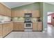 Kitchen features stainless steel appliances, light wood cabinets, and tiled flooring at 7441 Sugar Pine Ct, Avon, IN 46123
