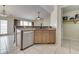 Open kitchen featuring a breakfast bar, white dishwasher, and light wood cabinets at 7441 Sugar Pine Ct, Avon, IN 46123