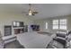 Spacious living room with plush carpeting, ceiling fan, and a comfortable leather sectional sofa at 7441 Sugar Pine Ct, Avon, IN 46123