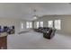 Open-concept living area featuring neutral carpet, vaulted ceiling, a ceiling fan, and a comfortable sofa at 7441 Sugar Pine Ct, Avon, IN 46123