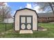 Well-maintained storage shed with double doors and a ramp in a private backyard setting at 7441 Sugar Pine Ct, Avon, IN 46123