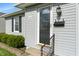 Close-up of the front entrance featuring a stylish door, modern lighting, and green landscaping at 844 Blanchard St, Shelbyville, IN 46176