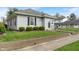 A quaint home with manicured lawn, brick foundation, and neutral siding at 844 Blanchard St, Shelbyville, IN 46176