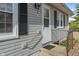 Charming front porch with a gray exterior and handrail provides curb appeal at 844 Blanchard St, Shelbyville, IN 46176