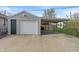 A detached one-car garage with an attached carport sits on a large concrete pad in a fenced yard at 844 Blanchard St, Shelbyville, IN 46176