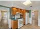 Open-concept kitchen with gas range and refrigerator, perfect for cooking at 844 Blanchard St, Shelbyville, IN 46176