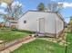 Backyard with a detached garage, grassy area, and a mix of concrete and stone pathways at 87 S 10Th Ave, Beech Grove, IN 46107