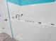 This bathroom features a walk-in bathtub with tile floors and turquoise wall at 87 S 10Th Ave, Beech Grove, IN 46107