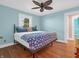 Cozy bedroom features laminate flooring, soft blue walls, and a paw print throw blanket at 87 S 10Th Ave, Beech Grove, IN 46107