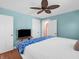 This bedroom features laminate flooring, soft blue walls, and a ceiling fan at 87 S 10Th Ave, Beech Grove, IN 46107