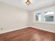 This bedroom features laminate floors, white trim, and a double window at 87 S 10Th Ave, Beech Grove, IN 46107