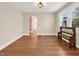 Bright dining room showcasing hardwood floors and natural light, with a view of the hall at 87 S 10Th Ave, Beech Grove, IN 46107