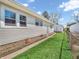 Exterior view of a home with vinyl siding, lush green lawn, and fenced yard at 87 S 10Th Ave, Beech Grove, IN 46107