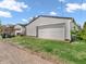 Detached garage with a white door, siding, and a grassy area with a dirt driveway at 87 S 10Th Ave, Beech Grove, IN 46107