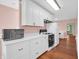 Modern kitchen with all-white cabinetry, stone countertops, and stainless-steel appliances at 87 S 10Th Ave, Beech Grove, IN 46107
