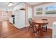 A spacious eat-in kitchen features bright white cabinets and modern appliances and hardwood style floors at 87 S 10Th Ave, Beech Grove, IN 46107