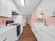 Efficient kitchen layout featuring white cabinets, stainless steel appliances, and hardwood floors at 87 S 10Th Ave, Beech Grove, IN 46107
