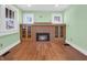 Living room with hardwood floors and decorative fireplace with built-in glass door cabinets at 87 S 10Th Ave, Beech Grove, IN 46107