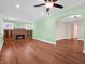 Spacious living room featuring a fireplace with brick surround, hardwood floors, and an arched doorway at 87 S 10Th Ave, Beech Grove, IN 46107