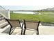 Outdoor patio with chairs offers serene lake views and easy access to backyard at 8755 Stoddard Ln, Indianapolis, IN 46217