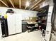 Unfinished basement area with storage solutions, utility features, and exposed ceiling beams at 8755 Stoddard Ln, Indianapolis, IN 46217