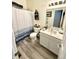 Bathroom featuring a shower with a white and blue curtain, sink, toilet and decor at 8755 Stoddard Ln, Indianapolis, IN 46217