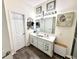 Well-lit bathroom features double sink vanity with framed seashell artwork at 8755 Stoddard Ln, Indianapolis, IN 46217