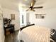 Bedroom with stylish decor, a ceiling fan, and an open doorway to an outdoor view at 8755 Stoddard Ln, Indianapolis, IN 46217