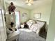 Bedroom with a daybed, desk, and carpet with neutral tones and good sunlight at 8755 Stoddard Ln, Indianapolis, IN 46217