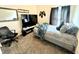 Bedroom with gray carpet, gray bed, and a TV for gaming and relaxation at 8755 Stoddard Ln, Indianapolis, IN 46217